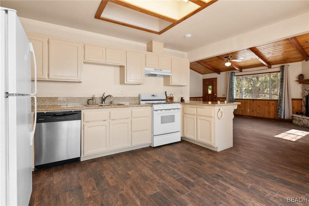 252 Riverside Avenue Sugarloaf, CA 92386 - Photo 9 of 29 a kitchen with white cabinets and white appliances