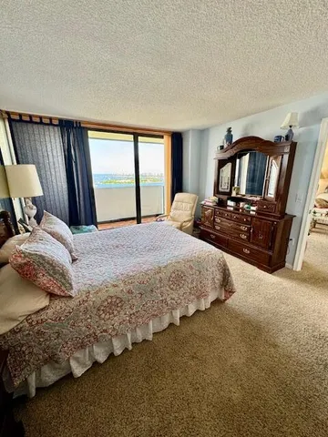 a bedroom with a bed next to a window with tv