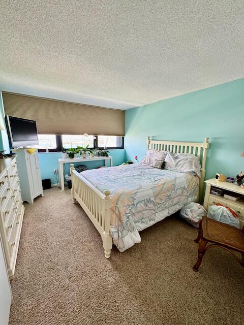 5600 North Flagler Drive, Unit 2701 West Palm Beach, FL 33407 - Photo 19 of 39 a bedroom with a bed and a chair