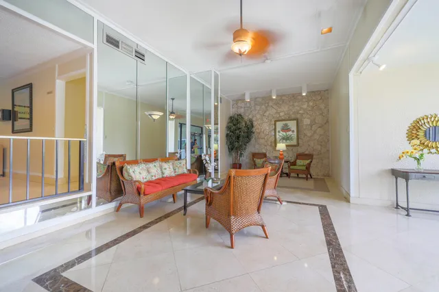 a dining room with furniture a chandelier and a rug