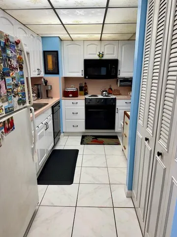 a kitchen with stainless steel appliances a refrigerator and a stove top oven