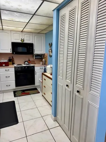 a kitchen with stainless steel appliances a refrigerator and a stove top oven
