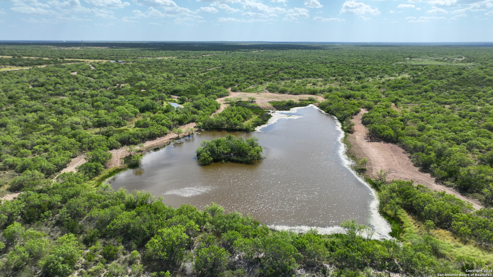 0 Cameron Lane Fowlerton, TX 78021 - Photo 2 of 16 an aerial view of a houses with outdoor space and trees all around