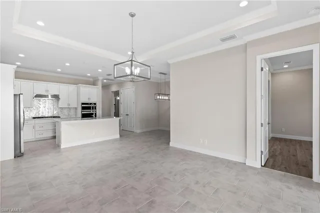 a view of a kitchen with a refrigerator a microwave and a sink