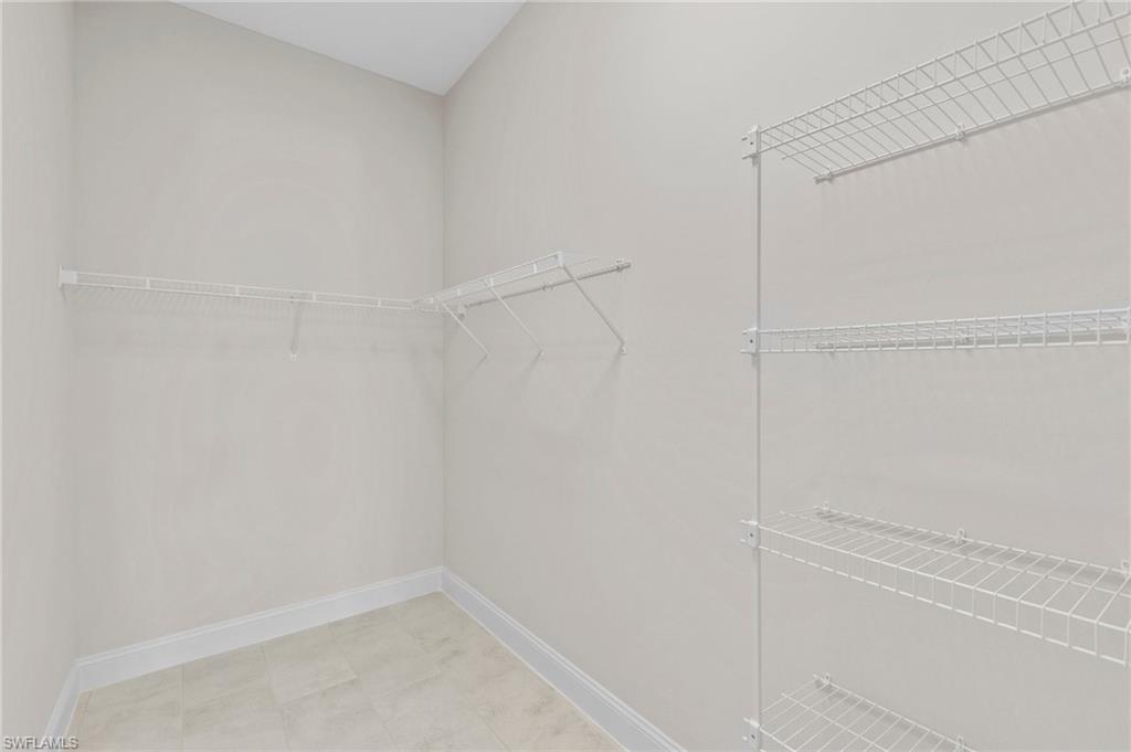 14756 Kingfisher Loop Naples, FL 34120 - Photo 16 of 31 a view of an empty walk in closet