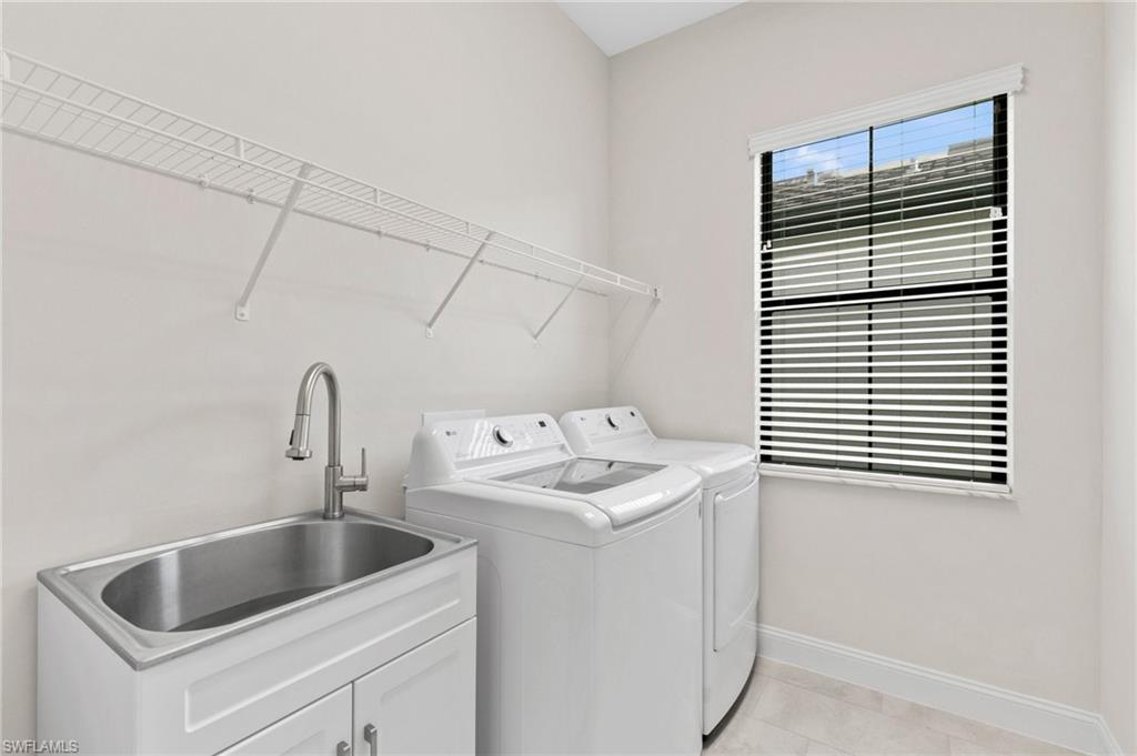 14756 Kingfisher Loop Naples, FL 34120 - Photo 18 of 31 a bathroom with a sink and cabinets