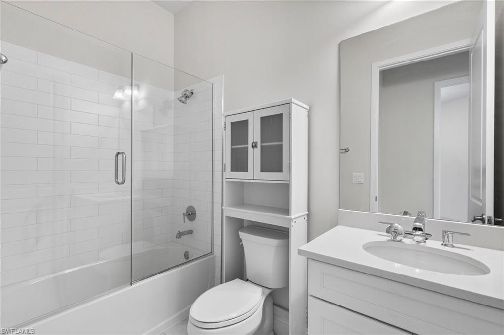 14756 Kingfisher Loop Naples, FL 34120 - Photo 19 of 31 a bathroom with a sink a toilet and shower