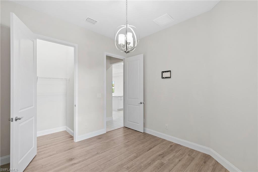 14756 Kingfisher Loop Naples, FL 34120 - Photo 20 of 31 a view of a livingroom with a wooden floor and a window