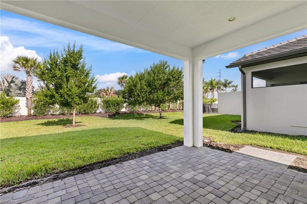 14756 Kingfisher Loop Naples, FL 34120 - Photo 22 of 31 a view of a back yard of the house