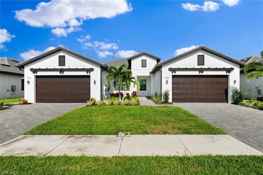 14756 Kingfisher Loop Naples, FL 34120 - Photo 25 of 31 a front view of a house with a yard and garage