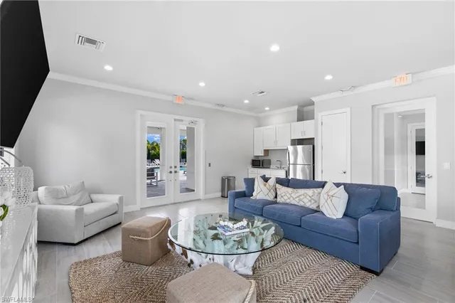 a front view of a house with a yard and potted plants