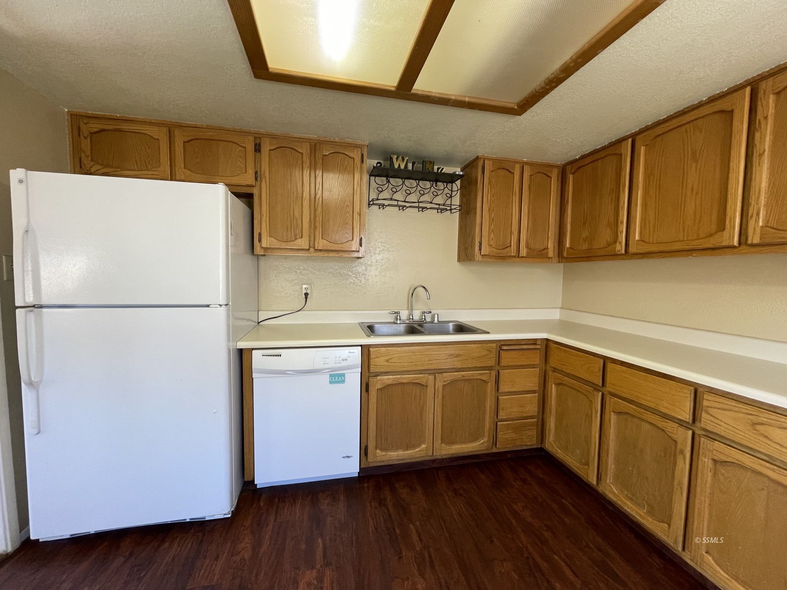 317 North Florence Street Ridgecrest, CA 93555 - Photo 5 of 19 a kitchen with a refrigerator sink and cabinets