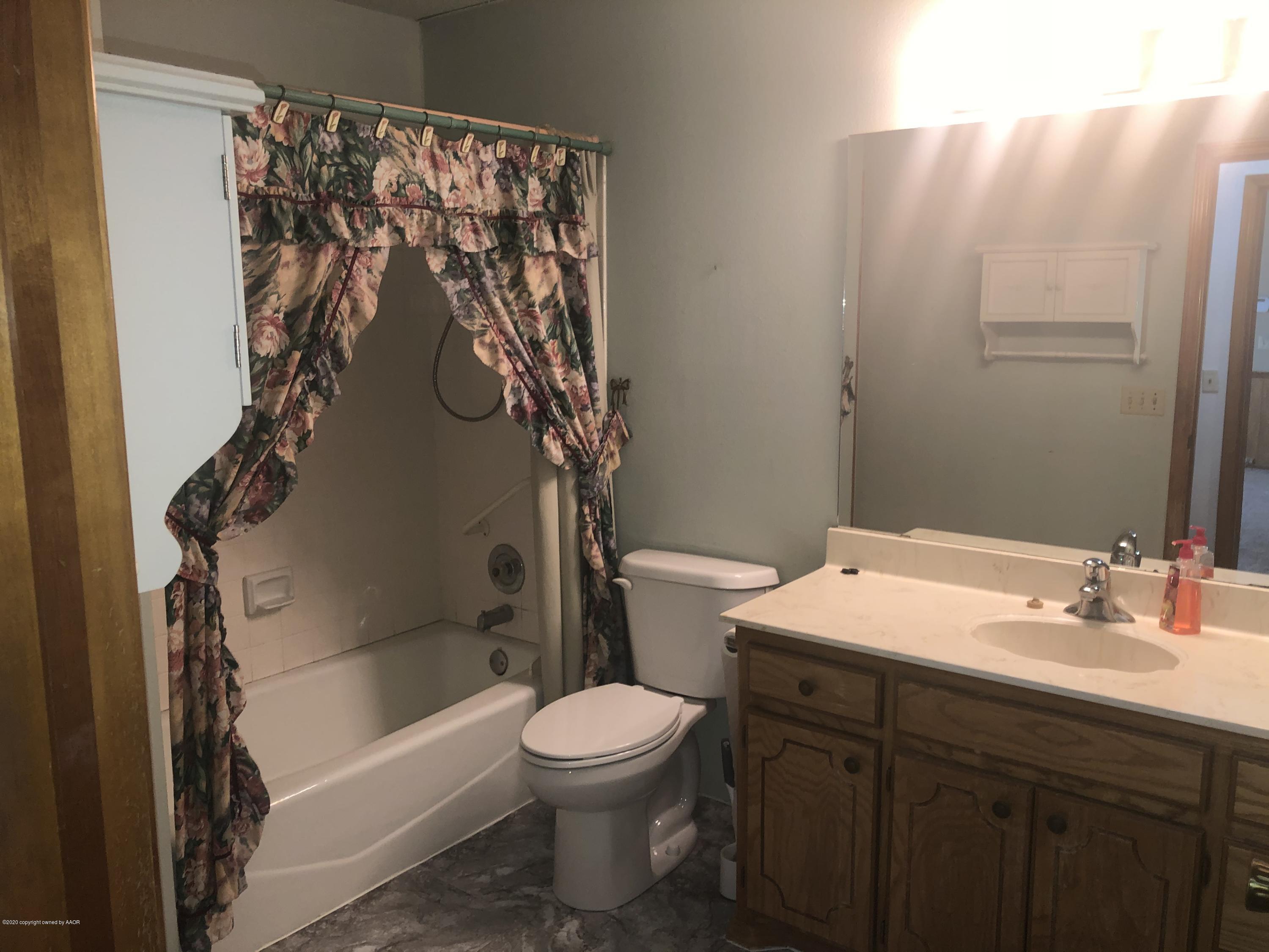 4601 South Travis Street Amarillo, TX 79110 - Photo 21 of 39 a bathroom with a sink toilet and shower