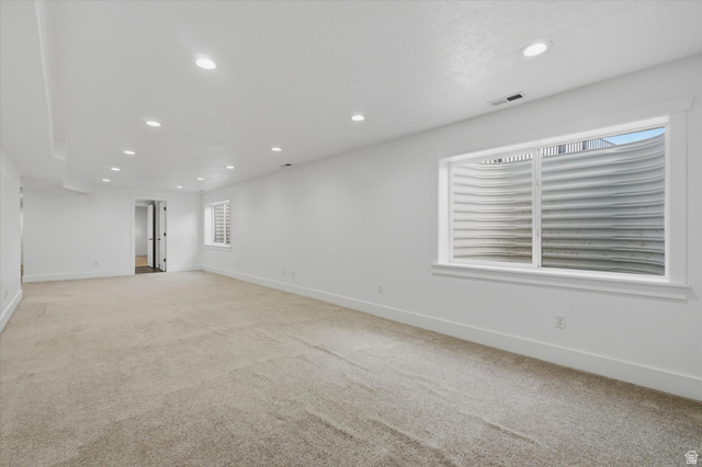791 East Saddle Road Grantsville, UT 84029 - Photo 30 of 46 Spacious room featuring neutral carpeting, recessed ceiling lighting, and a white color palette