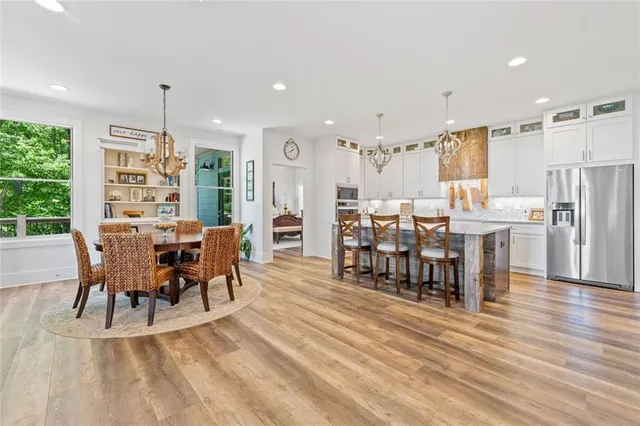 a kitchen with stainless steel appliances granite countertop a stove and cabinets
