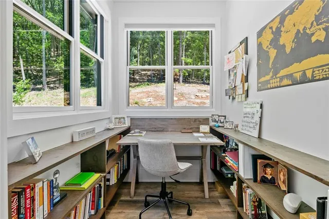 a view of a balcony with chairs and wooden floor