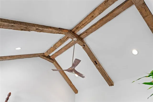 a balcony with wooden floor outdoor seating and yard in the back