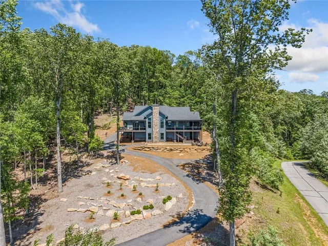 a living room with furniture a large window and a flat screen tv
