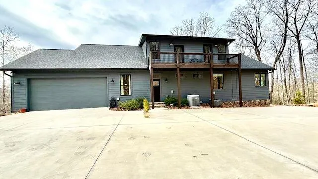 an aerial view of a house with a yard and lake view