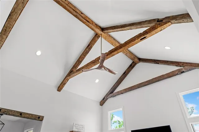 a dining room with stainless steel appliances kitchen island granite countertop a dining table chairs and a refrigerator