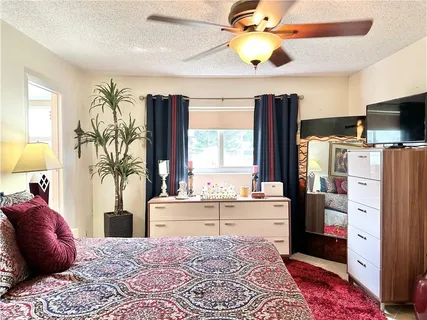 a bed room with a bed and a chandelier