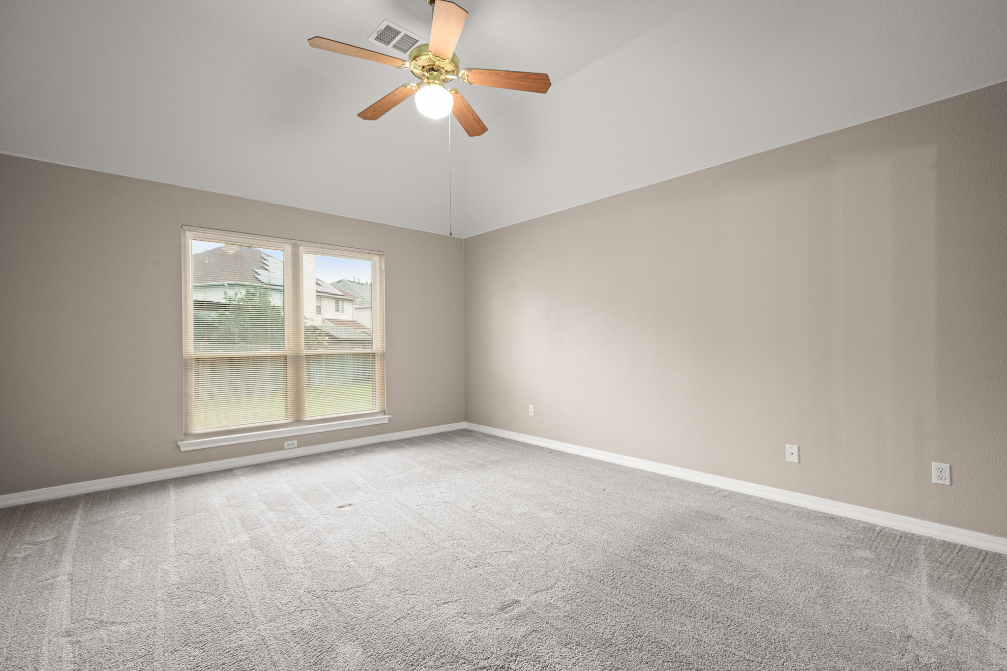 3420 Ribbon Reef Lane Austin, TX 78728 - Photo 11 of 25 Primary bedroom with carpet overlooks backyard