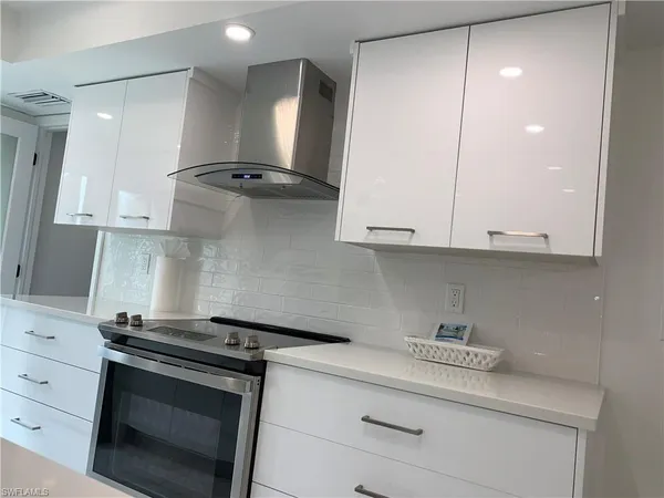 a kitchen with stainless steel appliances white cabinets and a stove