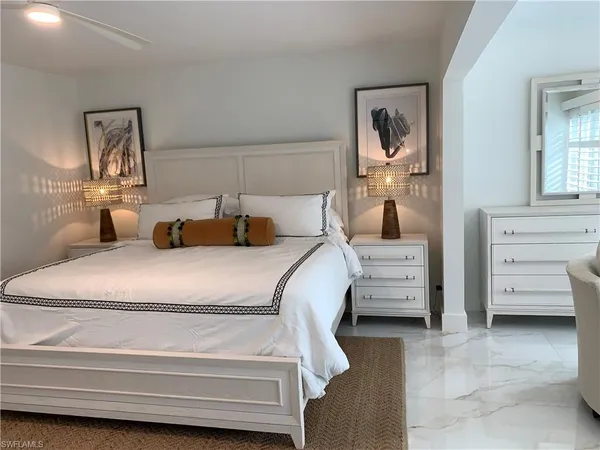 a bedroom with a bed and a mirror