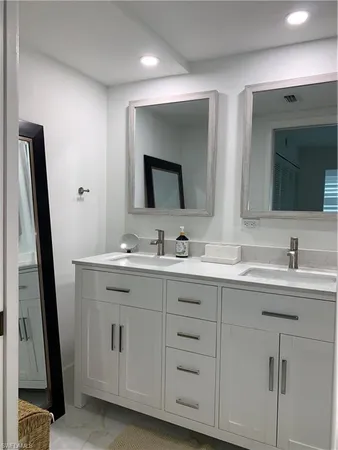 a bathroom with a double vanity sink and mirror