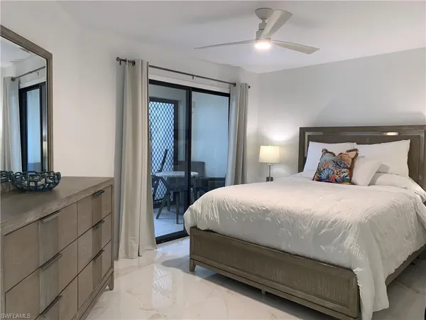 a bedroom with a bed and a mirror