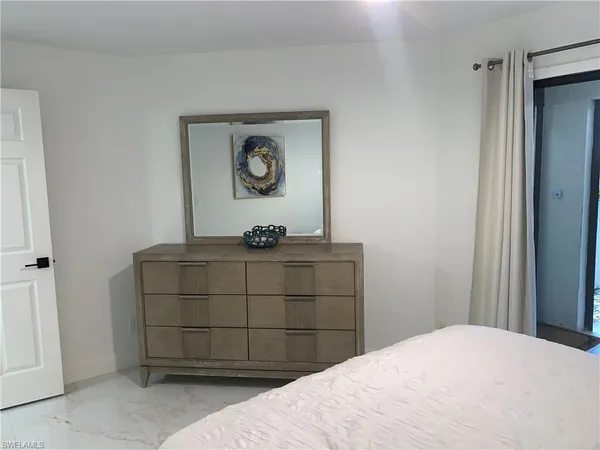 a bedroom with a bed and a table