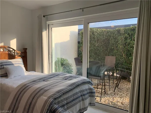 a bedroom with a bed and a view of balcony