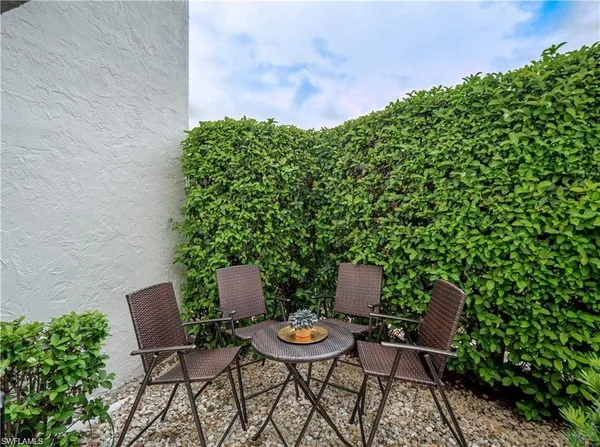a backyard of a house with table and chairs