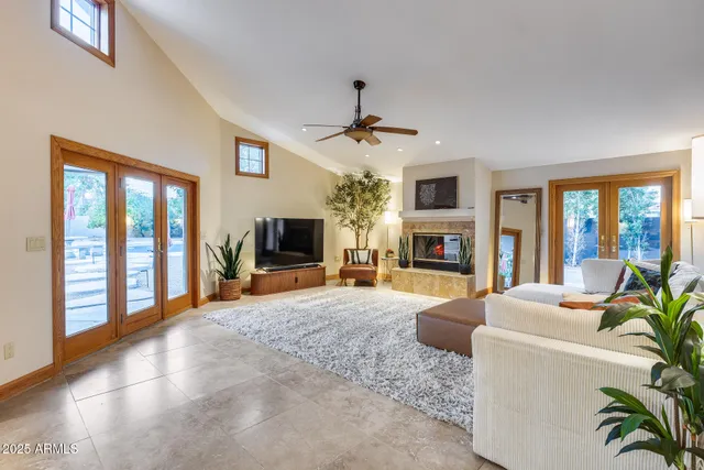 a living room with fireplace furniture and a flat screen tv
