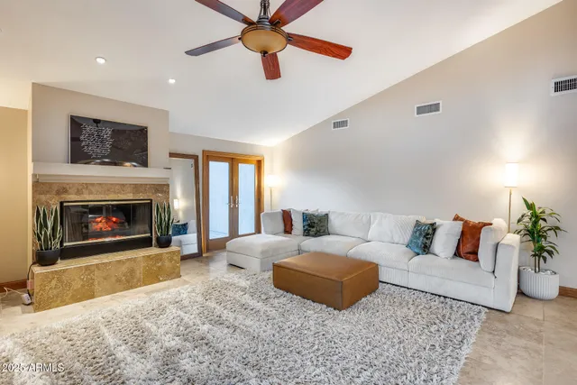 a living room with furniture and a fireplace