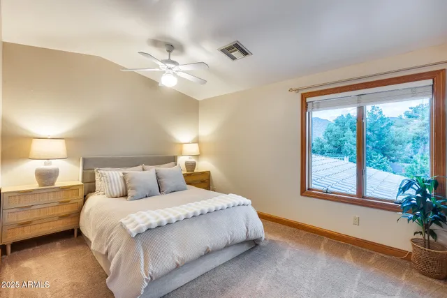 a bedroom with a large bed and a window