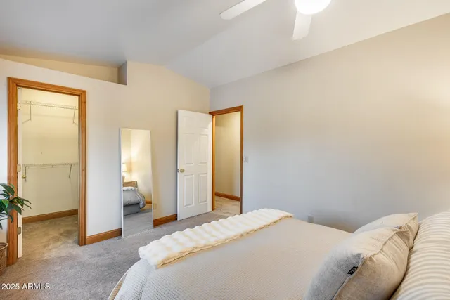 a bedroom with a bed and a painting on the wall