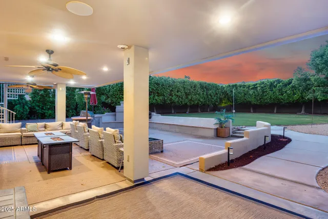 a large bedroom with large window and a table