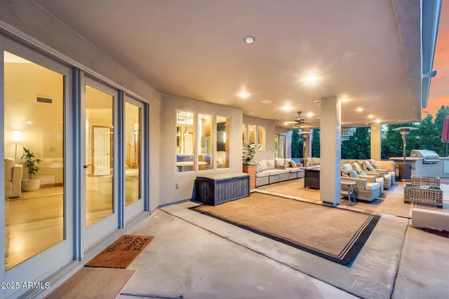 a living room with furniture and a floor to ceiling window