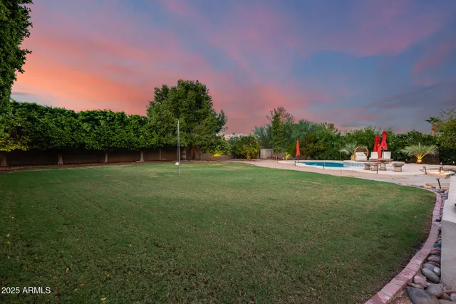 a view of a green field in front of a house