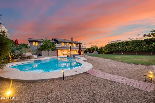 a view of a swimming pool with outdoor seating