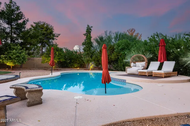 a view of a fire pit with trees in the background