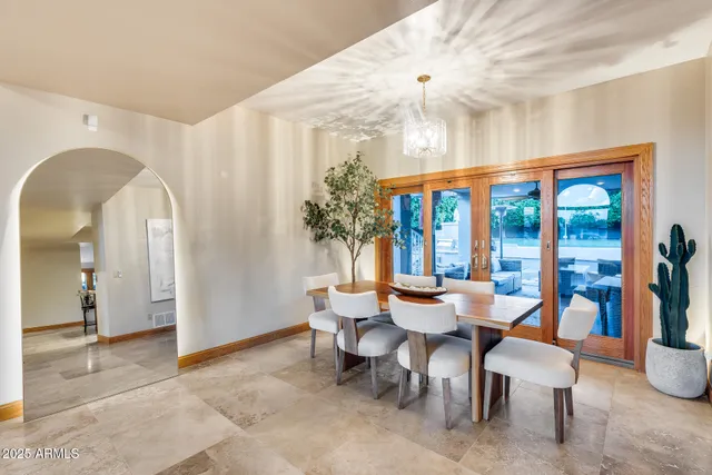 a view of a dining room with furniture and chandelier