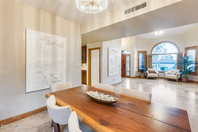a view of a dining room with furniture and a large window