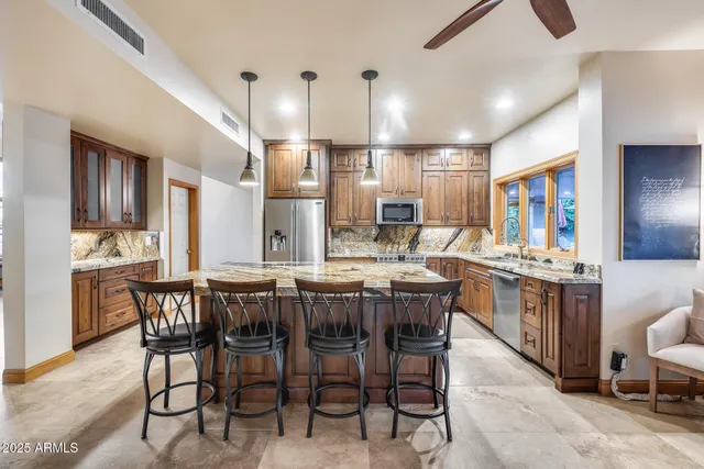 a large kitchen with a table and chairs