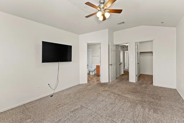 a view of a livingroom with an empty space and a ceiling fan