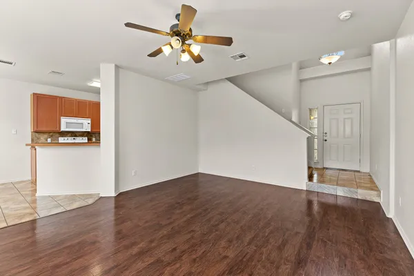 a view of an empty room with wooden floor