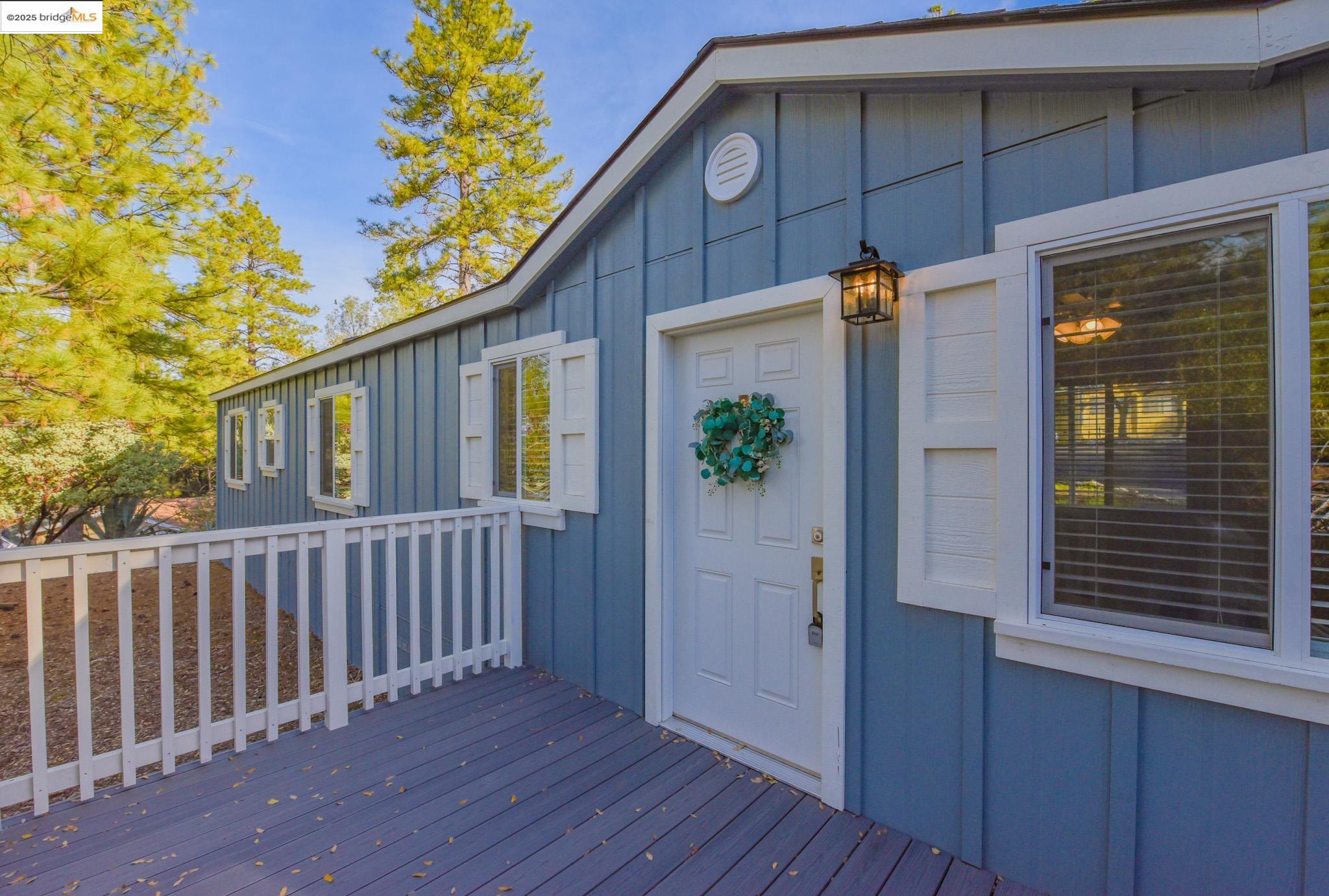 Property entrance featuring board and batten siding and a deck