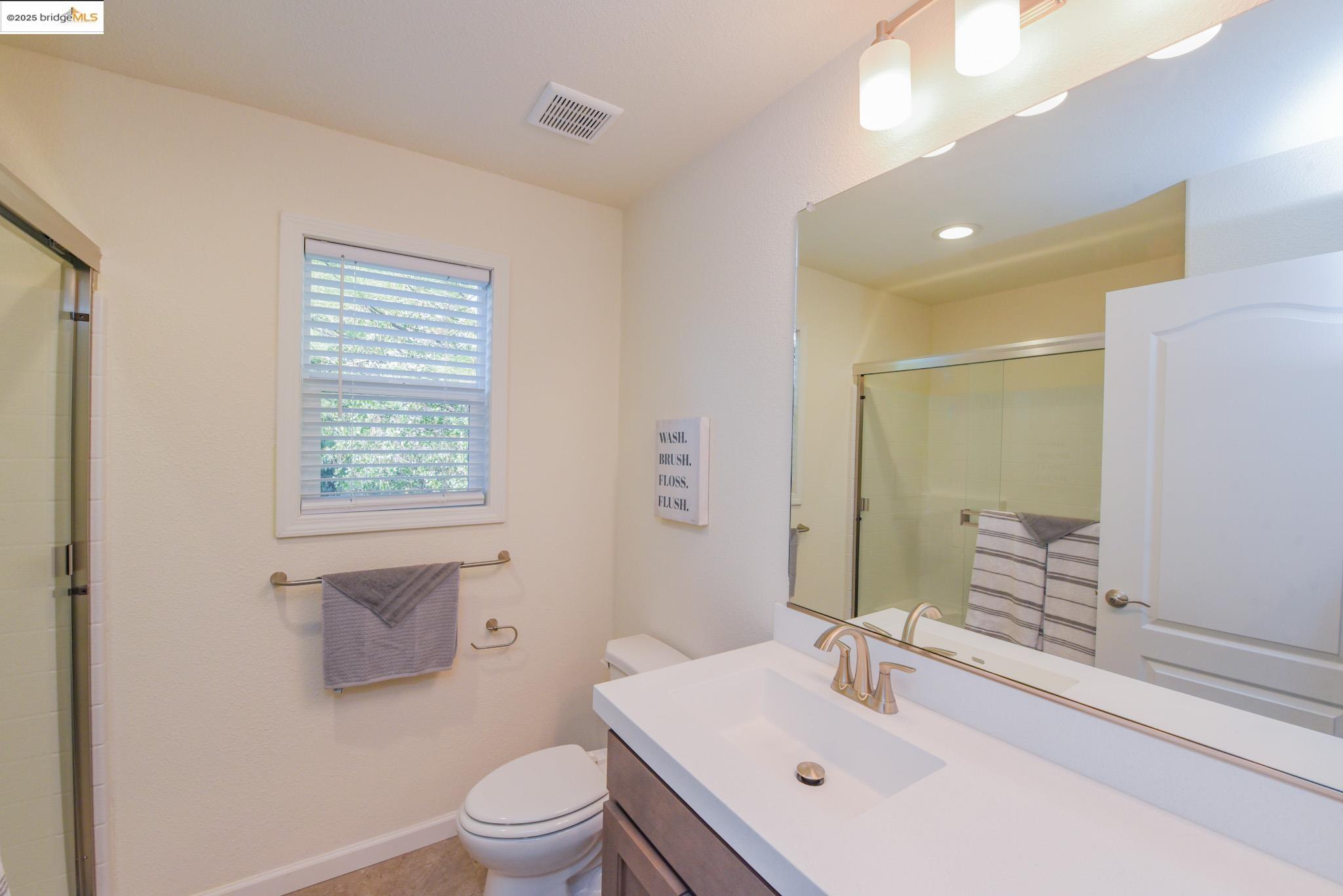 10956 Green Street Columbia, CA 95310 - Photo 18 of 45 a bathroom with a sink a toilet and a large mirror