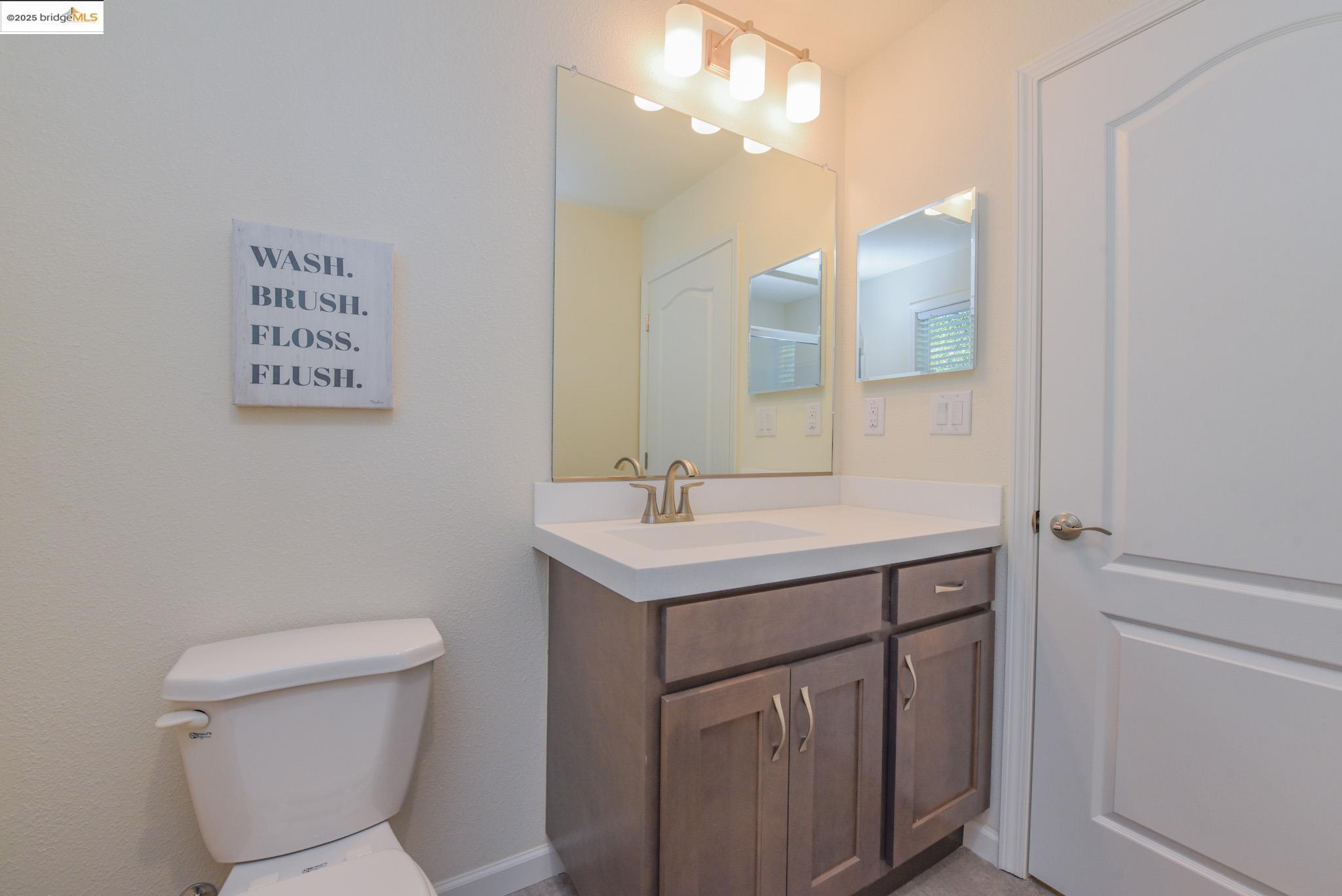 10956 Green Street Columbia, CA 95310 - Photo 20 of 45 a bathroom with a sink a toilet a mirror and vanity